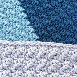 modern handmade crochet baby blanket in blue and grey color block design