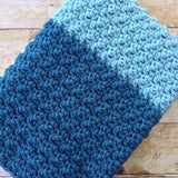 modern handmade crochet baby blanket in blue and grey color block design