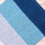 modern handmade crochet baby blanket in blue and grey color block design