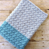 modern handmade crochet baby blanket in blue and grey color block design
