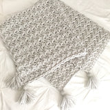 gender neutral baby blanket, crocheted in grey with corner tassels